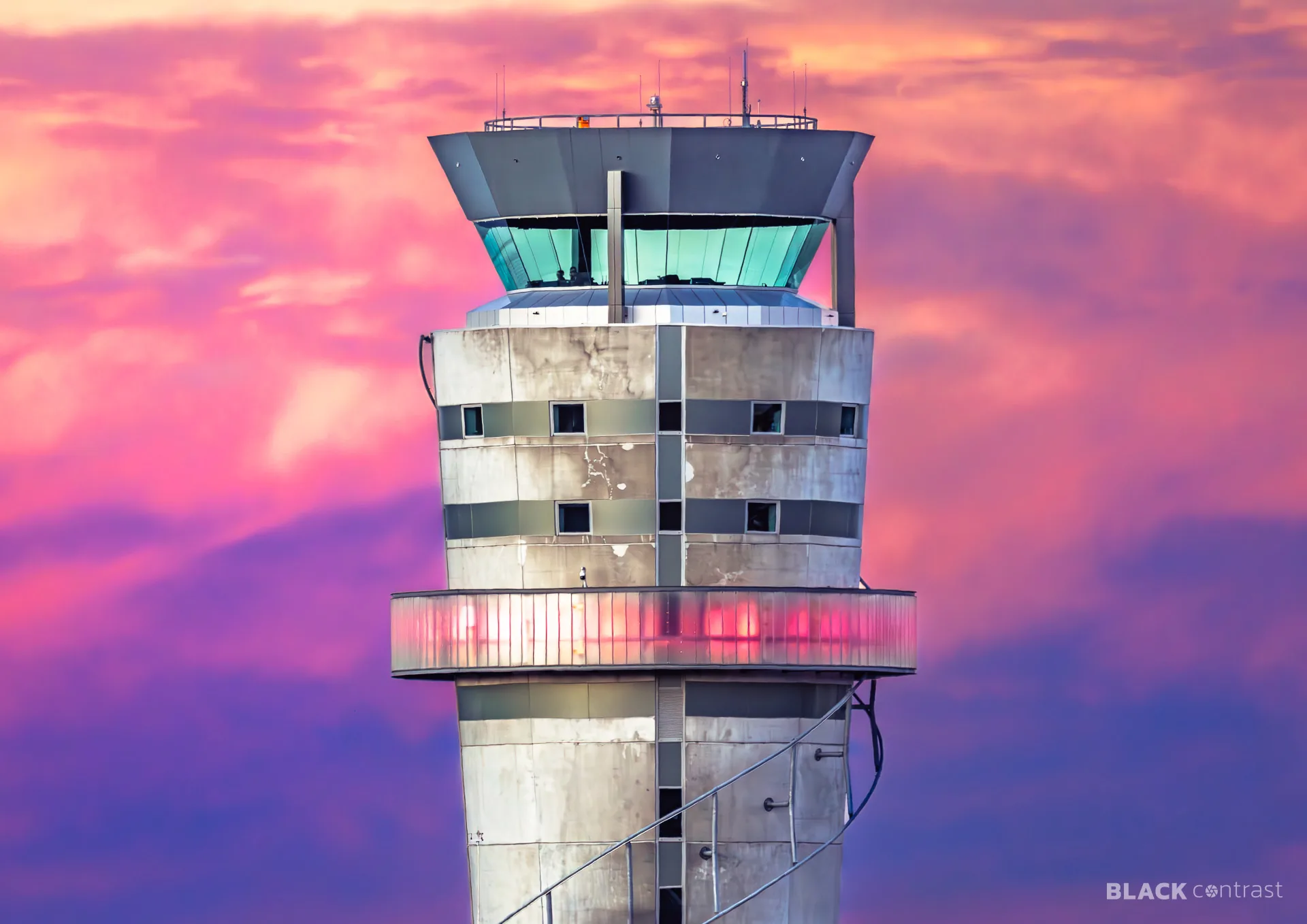 Christchurch air traffic control tower against a pink and purple evening sky